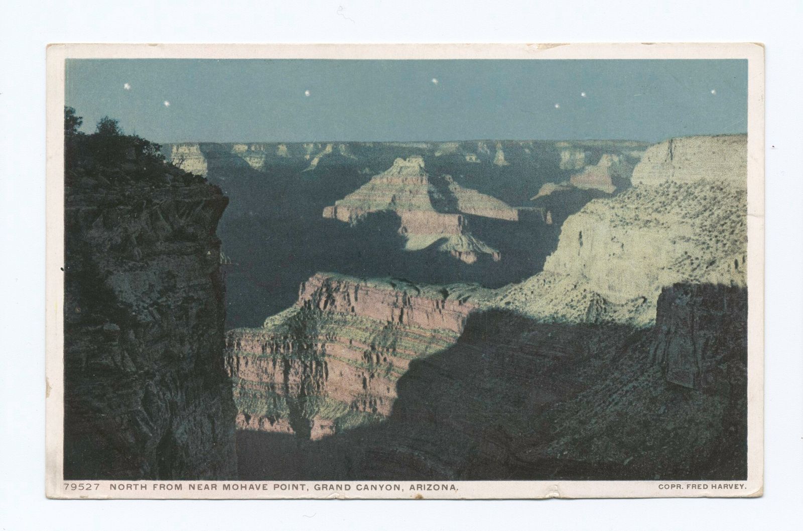 Vintage Fred Harvey Postcard from Mohave Point A vintage hand-colored postcard showing Grand Canyon's layered buttes and canyon depths viewed north from Mohave Point under a starlit sky.