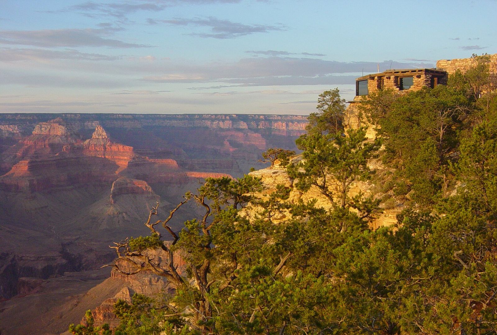 Yavapai Point Geology Museum perched on the South Rim overlooking the vast Grand Canyon at golden hour.