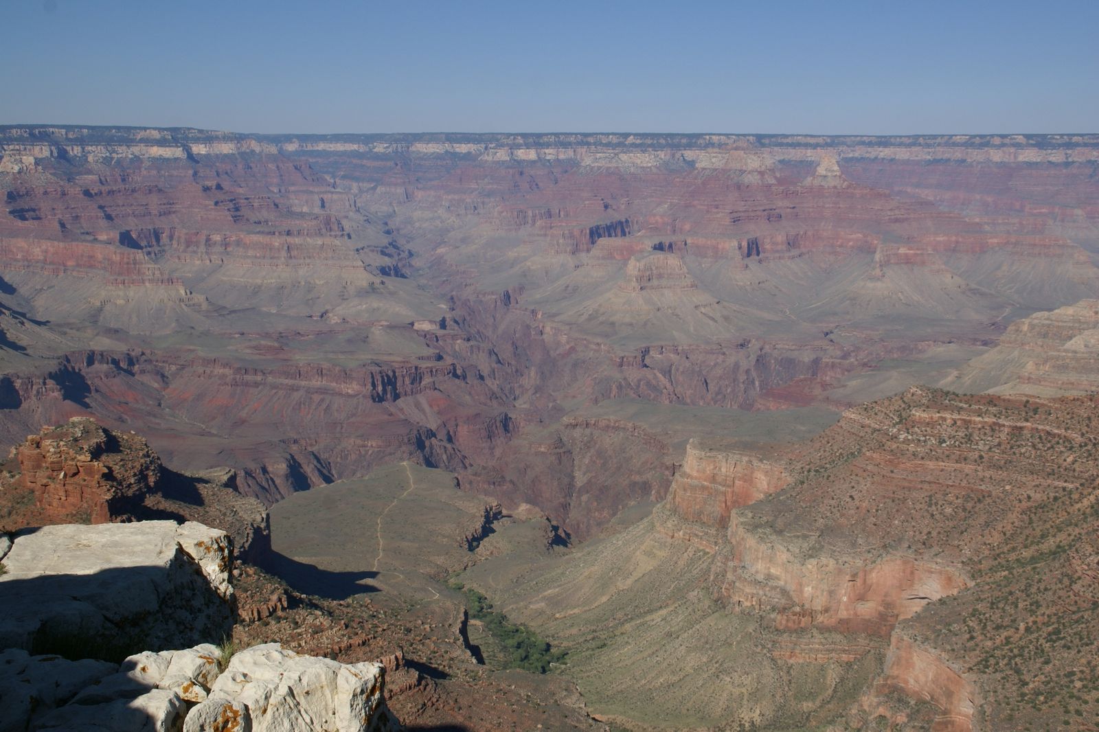 Panoramic Vista from Trailview Overlook, South Rim A sweeping panoramic view of the Grand Canyon's layered red and purple rock formations from the South Rim overlook.