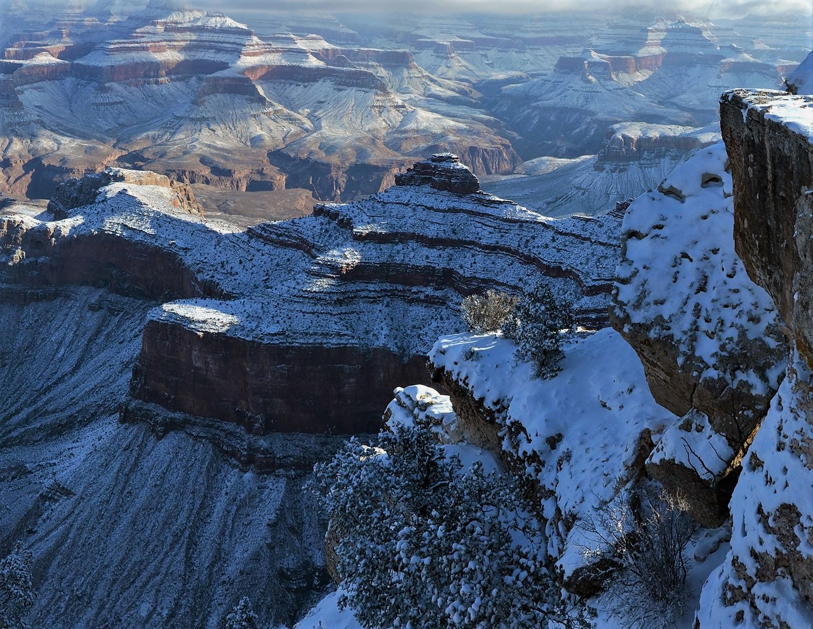 Snow blankets O'Neill Butte and layered canyon walls at Grand Canyon National Park in winter.