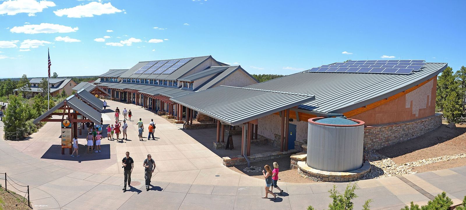 Grand Canyon South Rim Visitor Center The Grand Canyon South Rim Visitor Center building with solar panels and tourists walking outside on a sunny day.