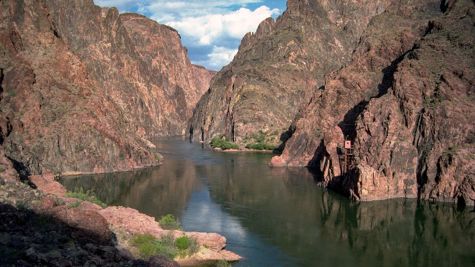 Colorado River Inner Gorge Near Phantom Ranch The calm Colorado River flows through the Inner Gorge near Phantom Ranch, flanked by towering dark schist walls.