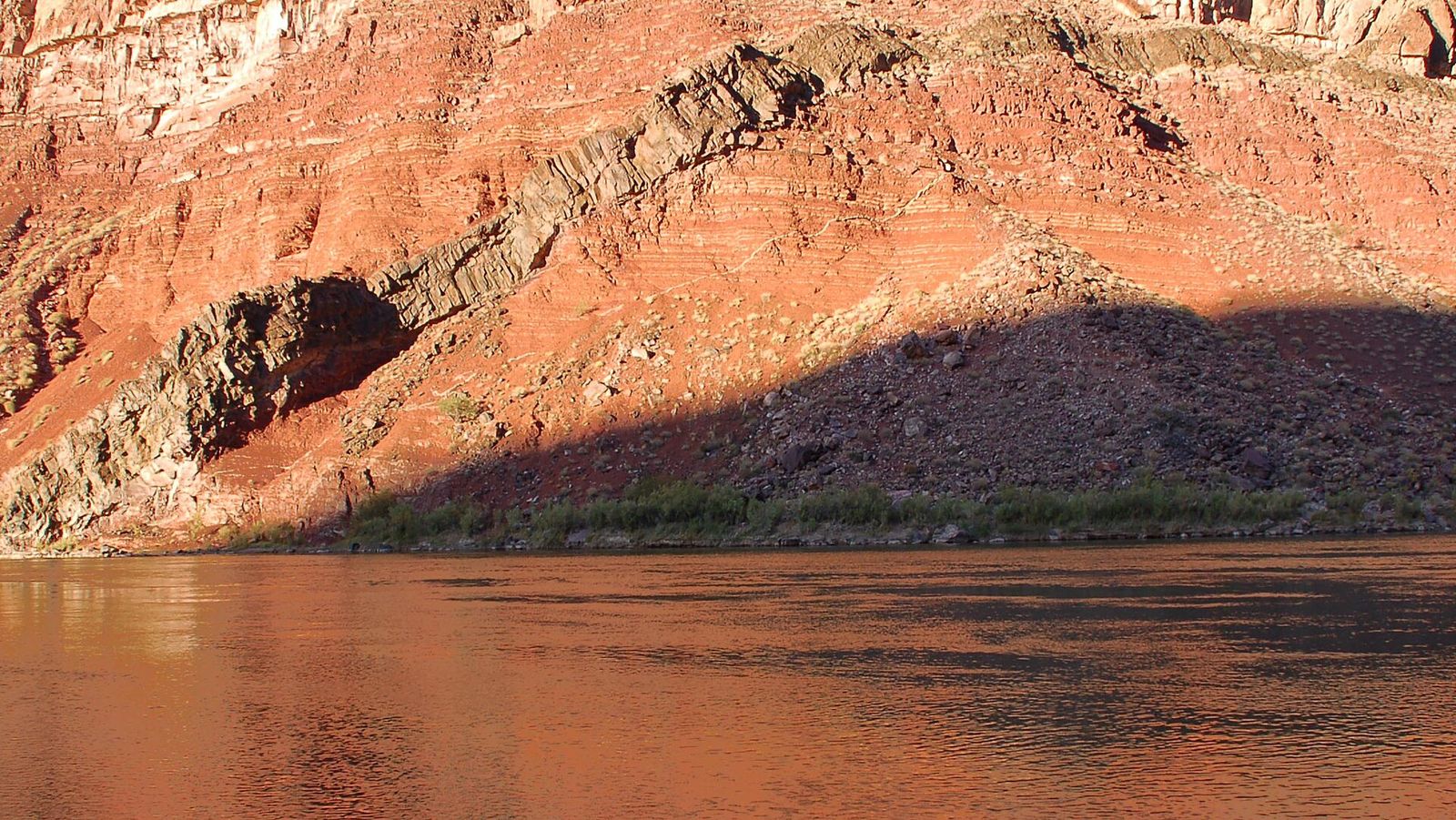 Colorado River and Hakatai Shale Canyon Walls The Colorado River flows past ancient Hakatai Shale canyon walls with dramatic layered red rock formations.