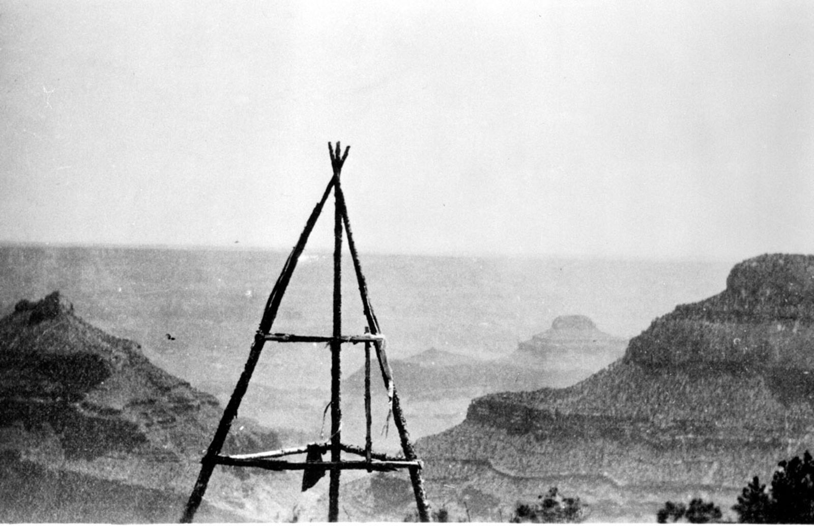 Historic Survey Cairn Near Tiyo Point, North Rim A wood-pole survey cairn stands near Tiyo Point on the Grand Canyon North Rim, circa 1904, with layered canyon buttes in the hazy distance.