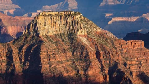 Deva Temple butte rises dramatically above layered red rock formations deep inside Grand Canyon National Park.
