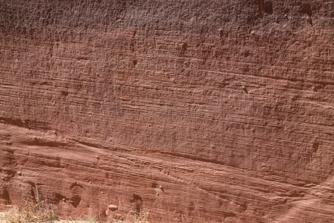 Ancient layered sandstone cliffs in Vermilion Cliffs National Monument reveal millions of years of Arizona geological history.