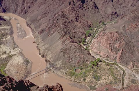 Aerial view of the Colorado River, Silver Bridge, and Bright Angel Campground deep inside Grand Canyon National Park.