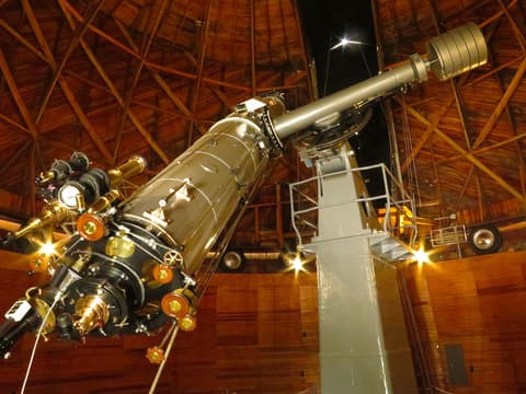 The historic Clark refractor telescope inside Lowell Observatory's wooden dome in Flagstaff, Arizona, near Grand Canyon.
