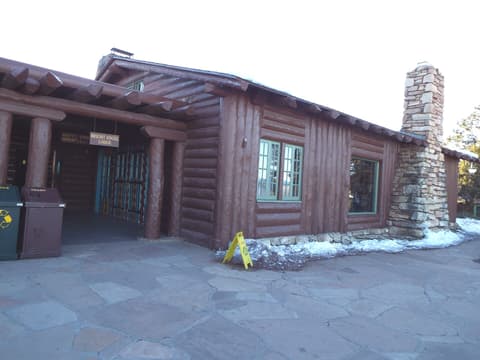 The rustic log exterior of Bright Angel Lodge on the South Rim of Grand Canyon in winter.
