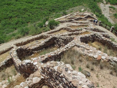 Aerial view of Tuzigoot National Monument's ancient Sinagua pueblo ruins with visitors exploring the hilltop site in Arizona.
