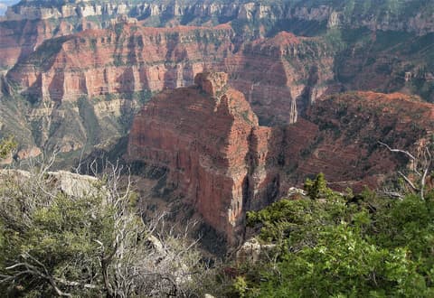 A massive red rock butte rises from the Grand Canyon's inner gorge viewed from the North Rim at Point Imperial.