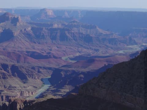 The Colorado River winds through the Grand Canyon's layered canyon walls as seen from Moran Point overlook.