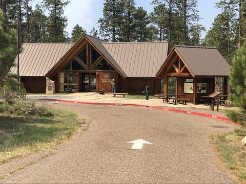 The Kaibab Plateau Visitor Center building surrounded by ponderosa pines near the Grand Canyon North Rim in Arizona.